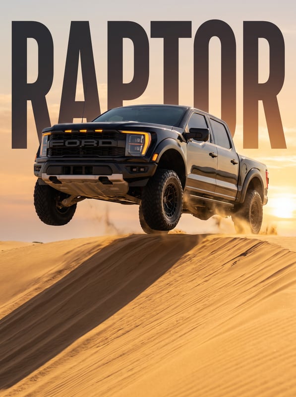 A Ford Raptor jumping a sand dune