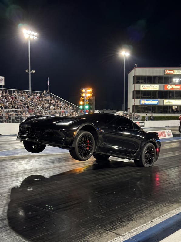 A Corvette Z06 pulling a wheelie at a drag strip